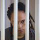 Brittney Griner waits for the verdict inside a defendants’ cage during a hearing in Khimki outside Moscow, on August 4, 2022.